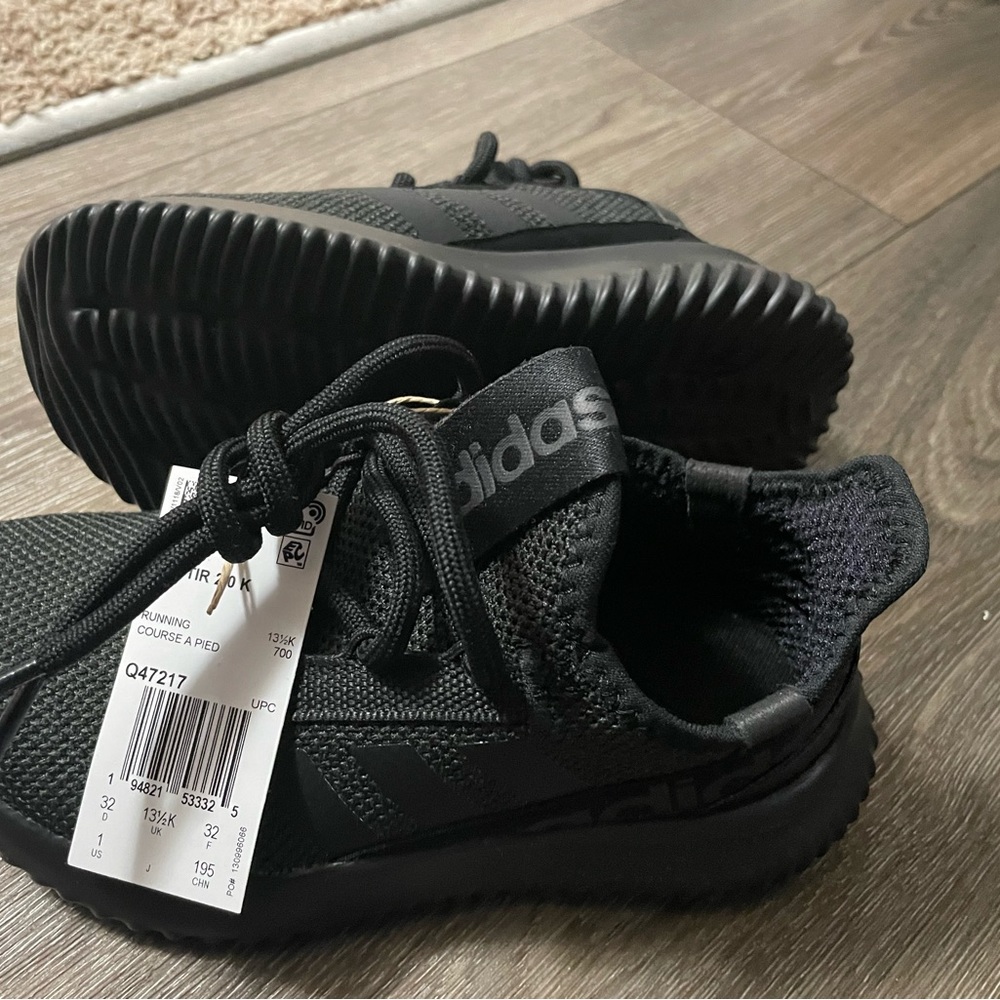 one pair of crocs black size 1 pair of Adidas sneakers size 1 in kids.